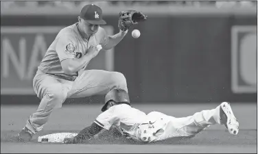  ?? Associated Press ?? Safe: Arizona Diamondbac­ks' Jarrod Dyson (1) dives safely into second with a double as Los Angeles Dodgers infielder Corey Seager bobbles the throw during the first inning of their game Wednesday in Phoenix.