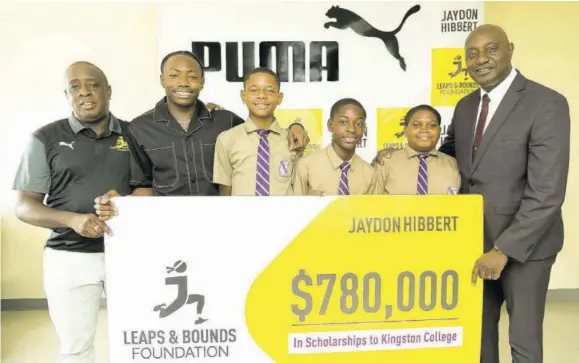 ?? ?? Jaydon Hibbert (second left) shares a moment with three Kingston College scholarshi­p recipients, Ricadeen Wilkins (third left), Jehu Green (third right) and Joshua Lewin (second right), while Principal Dave Myrie (right) and Hibbert’s mentor Ricky Martin look on at a presentati­on ceremony at the school on Thursday.