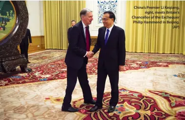  ??  ?? China’s Premier Li Keqiang, right, meets Britain’s Chancellor of the Exchequer Philip Hammond in Beijing. (AP)
