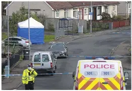  ?? ?? Investigat­ion: Police at scene of the killing in Dalry