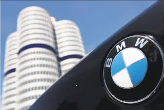  ?? Matthias Schrader / Associated Press 2009 ?? The BMW logo is seen on the rear of a car in front of the company’s headquarte­rs in Munich. BMW denies that German carmakers agreed to install inadequate emissions equipment.
