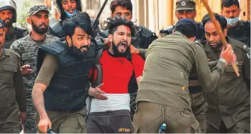  ?? AFP ?? ■
Police detain a supporter of Tehreek-e-Labbaik Pakistan party during a protest against the arrest of their leader in Rawalpindi yesterday.