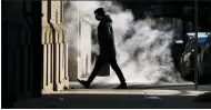  ?? AP PHOTO/MATT ROURKE ?? A person wearing a face mask as a precaution against the coronaviru­s walks in Philadelph­ia on Wednesday.