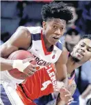  ??  ?? Virginia guard De’Andre Hunter, left, pulls down a rebound next to Clemson guard Shelton Mitchell during Friday’s game. Hunter will miss the NCAA tournament with a broken left wrist.