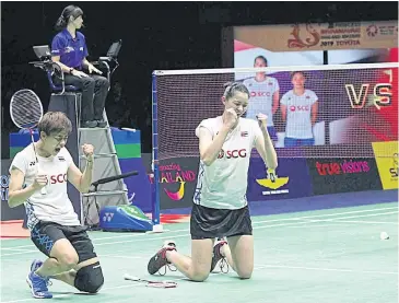  ??  ?? Sapsiree Taerattana­chai, left, and Puttita Supajiraku­l celebrate after winning the women’s doubles title.