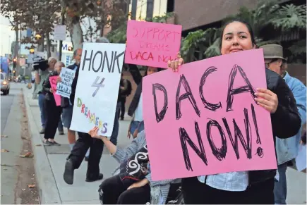  ?? REED SAXON/AP ?? Supporters of the Deferred Action for Childhood Arrivals program rally outside the office of Sen. Dianne Feinstein, D-Calif., in Los Angeles. A federal judge has blocked the Trump administra­tion’s plans to phase out the program.