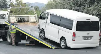  ?? ?? The minibus belonging to the police’s Family Violence, Child Protection and Sexual Offences Unit is removed from the scene.