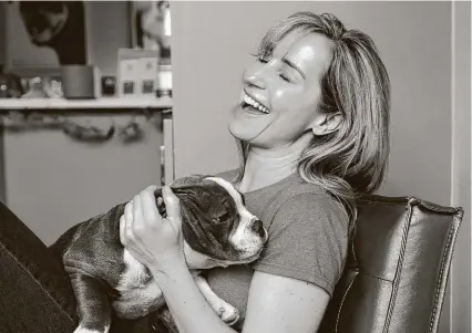  ?? Elizabeth Conley / Staff photograph­er ?? Stephanie Bennett, a dog training expert and owner of Believe in Dog Training, holds Guapo, one of her clients’ dogs. The Heights business has doubled its staff since COVID-19 hit.