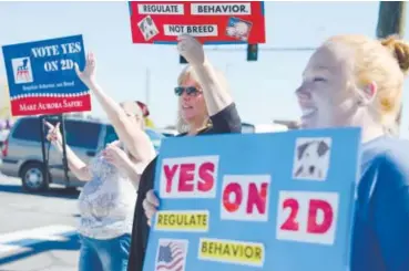  ??  ?? From left, Sheryl Powell, LauraMcMon­agle and Brittany Hanes express support for Propositio­n 2D at East Alameda Avenue and Potomac Street in Aurora on Saturday. Brent Lewis, The Denver Post