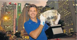  ?? Picture: GETTY IMAGES ?? ON SHOW: Todd Woodbridge holds up the Australian Open men’s trophy in Hong Kong, during the grand slam trophy tour last year