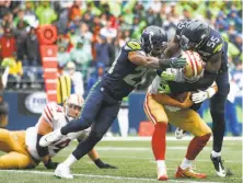  ?? Otto Greule Jr / Getty Images ?? Free safety Earl Thomas (29) and defensive end Frank Clark (55) of the Seahawks sack 49ers quarterbac­k Brian Hoyer.
