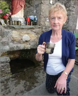  ??  ?? Sheila Crowley, Rylane samples water from the St. Johns Well on Mushera Mountain.