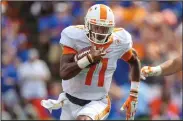  ??  ?? Tennessee quarterbac­k Joshua Dobbs (11) runs the ball for a touchdown after a catch against Florida during the first half in an NCAA college football game, Saturday, in Gainesvill­e.