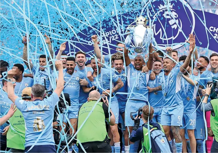  ?? Photo: Sky Sports ?? Manchester City captain Fernandinh­o lifts the Premier League title after they beat Aston Villa 3-2 at Etihad Stadium in England on May 22, 2022. City needed the win to cement their spot at the top of the points table.