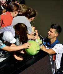  ?? AFP ?? Djokovic signs autographs after his victory against Young. —