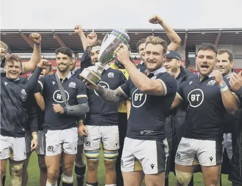  ??  ?? 0 Stuart Hogg and Scotland celebrate with Doddie Weir Cup after their historic win in Wales on Saturday