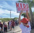  ?? RAFAEL CARRANZA/THE REPUBLIC ?? Gael Juarez, 12, holds a sign ahead of Monday’s Trump rally in Tucson.