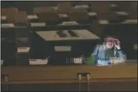  ??  ?? Empty tables in a conference room are seen reflected in a translator’s booth as he works Wednesday.