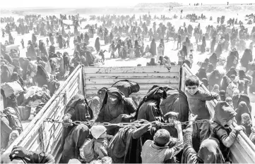  ??  ?? Women and children evacuated from the Islamic State (IS) group’s embattled holdout of Baghouz arrive at a screening area held by the US-backed Kurdish-led Syrian Democratic Forces (SDF), in the eastern Syrian province of Deir Ezzor.— AFP photo