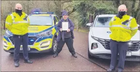  ??  ?? Fermoy man Seán McCarthy, pictured with Garda Peter O’Loughlin and Garda Séamus Luddy of the Roads Policing Unit, receiving his certificat­e and commemorat­ive medal to mark his successful completion of the Jerusalema Challenge.