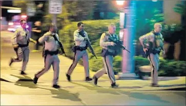  ?? John Locher Associated Press ?? POLICE RACE toward the Mandalay Bay Resort and Casino on Oct. 1, during the mass shooting that left 58 people dead. About three hours of police body-camera video from that evening have been released.