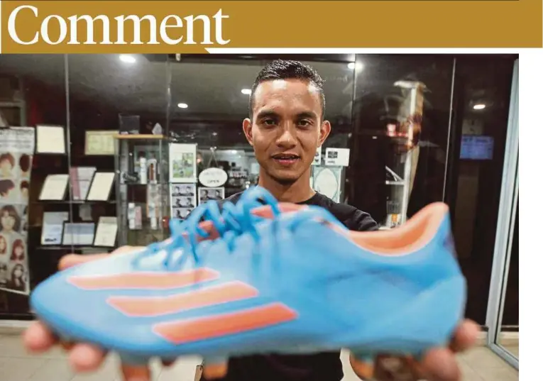  ??  ?? Mohd Faiz Subri showing the shoes that he wore when he scored the ‘fantasy goal’ ina Super League match in Penang in February.
