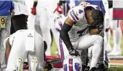  ?? ASSOCIATED PRESS ?? Bills players pray for teammate Damar Hamlin after the second-year safety collapsed on the field early in Monday’s game in Cincinnati.