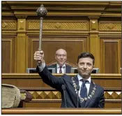  ?? AP/ANDRII NESTERENKO ?? The new Ukrainian President Volodymyr Zelenskiy holds up a mace, the Ukrainian symbol of power, during his inaugurati­on ceremony Monday in Kiev, Ukraine.
