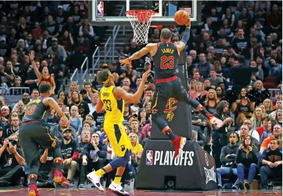  ?? Getty Images ?? LeBron James of the Cleveland Cavaliers drives around Myles Turner (No.33) of the Indiana Pacers to score. —