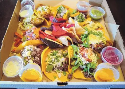  ?? RICHARD S. DARGAN/FOR THE JOURNAL ?? Tako Ten’s Circle of Friends offers one of each of the restaurant’s 10 tacos, along with samples of its salsas.