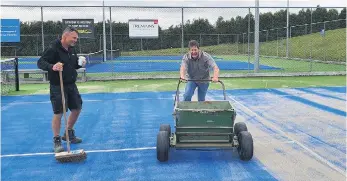  ??  ?? Spreading one tonne of sand on Courts 1 and 2. PHOTO: Supplied.