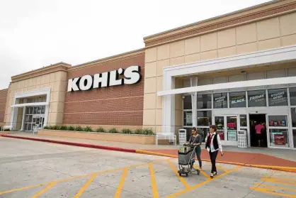  ?? AP ?? SHOPPERS push a cart of items as they leave Kohl’s in Corpus Christi, Texas (above). Kohl’s is testing off-price stores, smaller-format stores, investing more in ecommerce and sprucing up its beauty business.