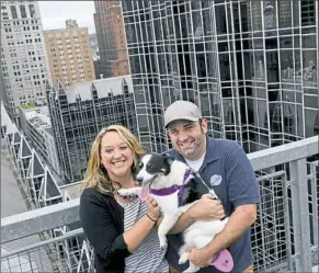  ??  ?? Mr. Konecky’s wife, Carley Kimmell, joins him and Lily on Town Place’s rooftop dog park. See video at post-gazette.com.