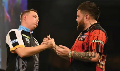  ?? ?? Chris Dobey (left) shakes hands with Michael Smith after his 4-0 victory at the PDC World Championsh­ips. Photograph: Simon West/ Action Plus/Shuttersto­ck