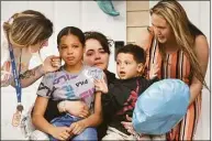  ?? ?? Jeilany Vega’s family watch as “The Joy for Jeilany Caravan” passes in front of their home in Ansonia. Jeilany is in the hospital and could not attend.