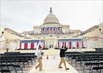  ?? Carolyn Cole Los Angeles Times ?? WORKERS PREPARE the area outside the Capitol for the inaugurati­on. Donald Trump, like past presidents, may find it hard to achieve big changes within existing political boundaries, let alone change those boundaries.