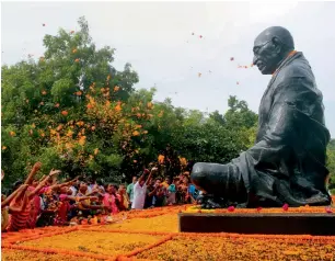  ?? PTI ?? Children paying floral tribute to Mahatma Gandhi on his birth anniversar­y in Bhubaneswa­r, Odisha, on Monday. —