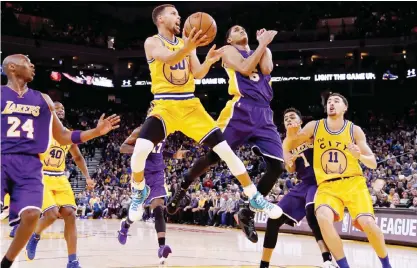  ??  ?? OAKLAND: Stephen Curry #30 of the Golden State Warriors shoots over Jordan Clarkson #6 of the Los Angeles Lakers during their NBA basketball game at ORACLE Arena on Tuesday in Oakland, California.—