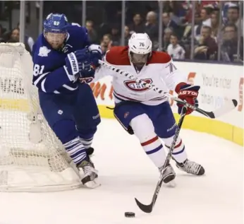  ?? ANDREW FRANCIS WALLACE/TORONTO STAR ?? Habs defenceman P.K. Subban holds off the Leafs’ Phil Kessel as he pursues the puck behind the net Saturday.