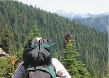  ?? Michael Furniss / Special to The Chronicle ?? A hiker takes in the view of the Marble Mountain Wilderness, a farnorth retreat 235 times the size of Golden Gate Park.