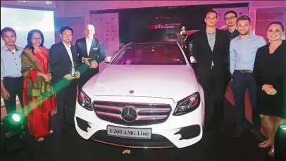  ??  ?? Mercedes-Benz Malaysia general manager Carsten Bauer (fourth from left) and his team posing with a Mercedes-Benz E-Class displayed in the ballroom during the gala dinner.