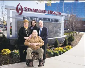  ?? Contribute­d photo ?? New signs have been installed at the entrance to Stamford Hospital, whose campus is also known as the Bennett Medical Center. The Bennett family has given a total of more than $20 million to the hospital. In front center is Carl Bennett. In back, from left, are Robin Bennett-Kanarek; Kathy Silard, CEO of the Stamford Health system; and Marc Bennett.