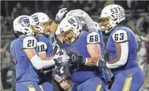  ?? LORRIE CECIL/THISWEEK ?? Gahanna's Gabe Bushelman (21) Dylan Scott (48), Ben Morris (68) and Isaac Perkins (63) celebrate their win over New Albany on Friday.