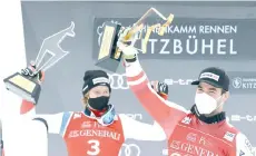  ?? - AFP photo ?? Vincent Kriechmayr (right) and second placed Marco Odermatt celebrate on the podium after the men’s Super-G event.