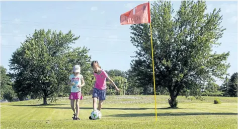  ?? JULIE JOCSAK/POSTMEDIA NEWS ?? Stacey Julie, 8, and sister Clara, 5, play a hole of footgolf at the Brock Golf Course in Thorold.