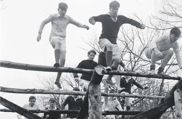  ??  ?? Gordonstou­n pupils taking part in physical training over an obstacle course at the famously tough school in Morayshire