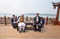  ?? Handout via Reuters - India’s Press Informatio­n Bureau/ ?? INFORMAL SUMMIT: India’s Prime Minister Narendra Modi speaks with Chinese President Xi Jinping as they take a boat ride on the East Lake in Wuhan, China, April 28, 2018.