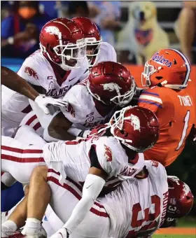  ?? (University of Arkansas/Walt Beazley) ?? The Arkansas defense gang-tackles Florida’s Kadarius Toney during Saturday’s game. The Razorbacks became the first team this season to stop the Gators from scoring after they had the ball inside the opponent’s 20.