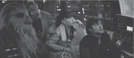  ?? DISNEY ?? Joonas Suotamo, left, as Chewbacca, Woody Harrelson as Tobias Beckett, Emilia Clarke as Qi’ra and Alden Ehrenreich as Han Solo in the second stand alone Star Wars movie Solo: A Star Wars Story.