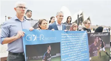  ?? — AFP photo ?? Human rights groups and the Australian football community hold a protest in front of the Opera House for the release of Alaraibi in Sydney.